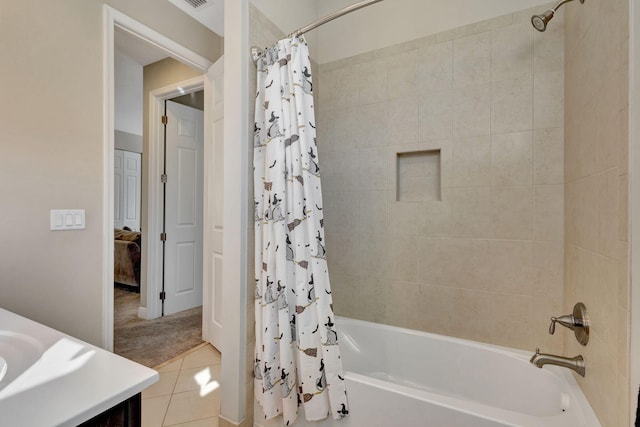 bathroom featuring tile patterned flooring, vanity, and shower / bath combo with shower curtain