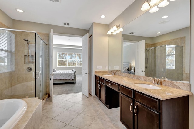 bathroom featuring tile patterned floors, vanity, and shower with separate bathtub