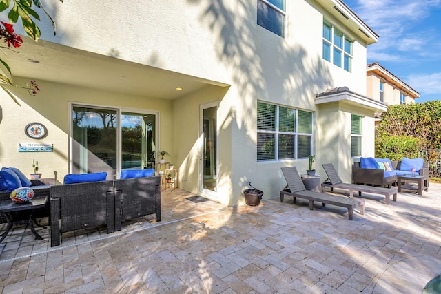 rear view of house featuring an outdoor hangout area and a patio