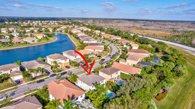 birds eye view of property with a water view