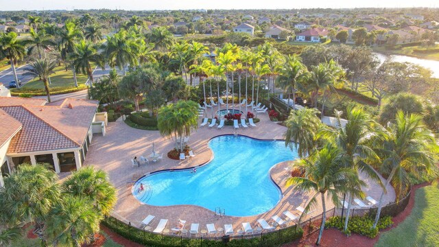 rear view of property with a swimming pool with hot tub, an outdoor hangout area, and a patio area