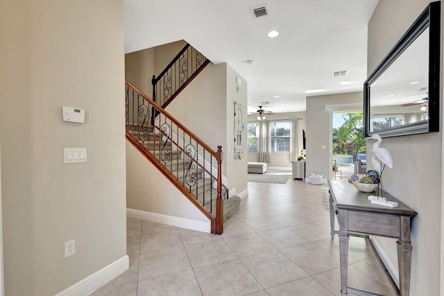 foyer with ceiling fan and light tile patterned floors