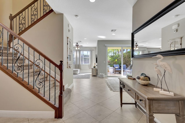 tiled entryway with ceiling fan