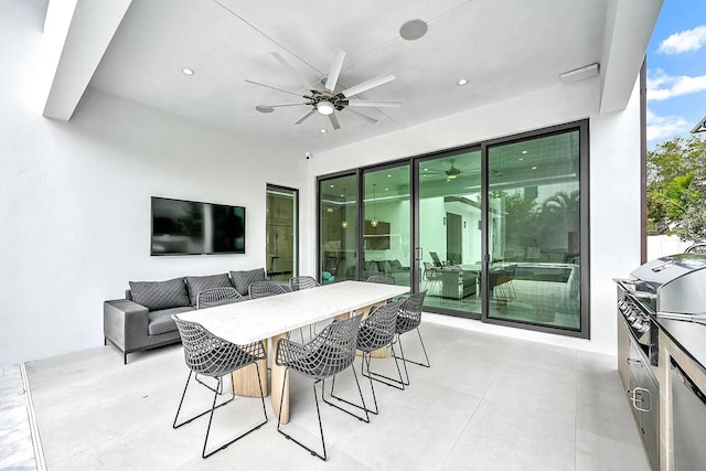 view of patio / terrace featuring area for grilling, outdoor lounge area, ceiling fan, and exterior bar