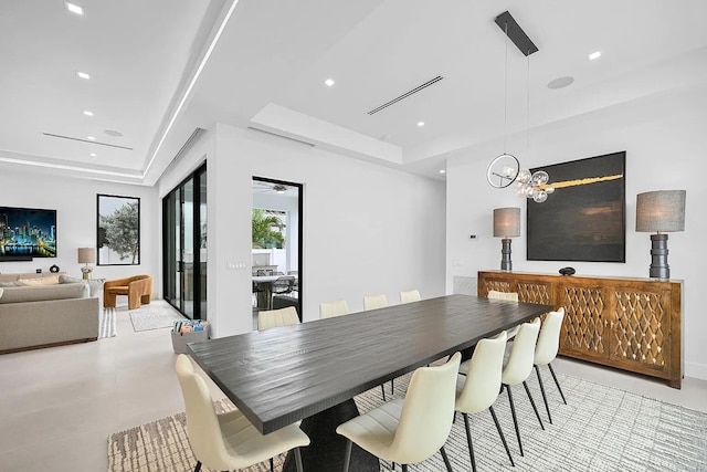 dining area with a raised ceiling