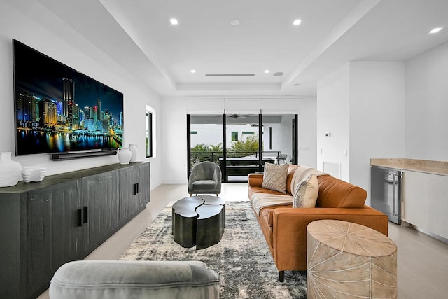 living room featuring beverage cooler and a raised ceiling