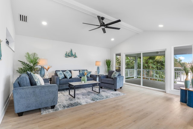 living room with beam ceiling, visible vents, and light wood-style floors