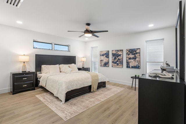 bedroom featuring light wood finished floors, baseboards, visible vents, and recessed lighting