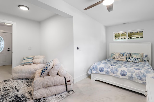 bedroom featuring baseboards, visible vents, and a ceiling fan