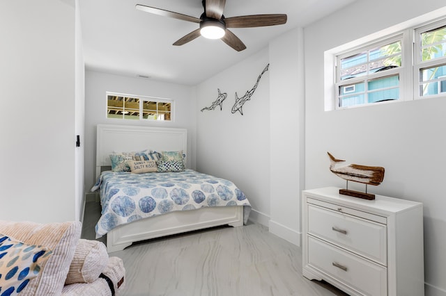 bedroom with a ceiling fan, multiple windows, visible vents, and baseboards