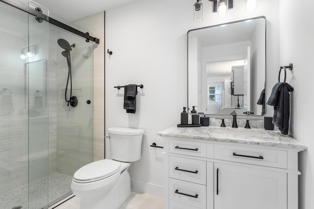 full bathroom with toilet, a shower stall, baseboards, and vanity