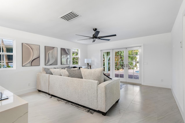 living area with french doors, a ceiling fan, visible vents, and baseboards