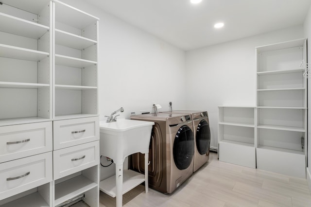 laundry area featuring laundry area, washing machine and dryer, light wood-style flooring, and recessed lighting