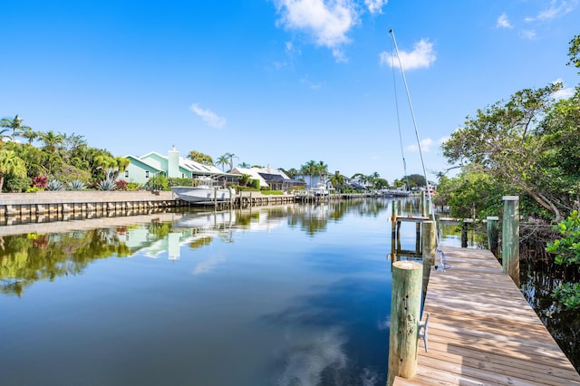 dock area with a water view and boat lift