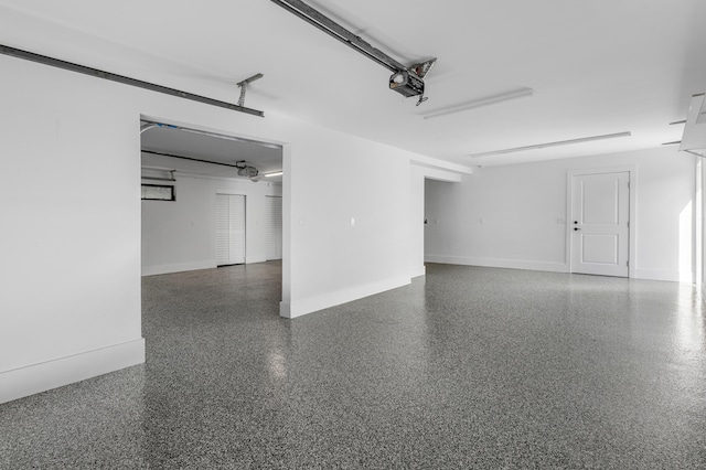 garage with a garage door opener and baseboards