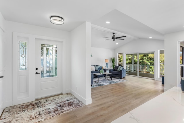 foyer featuring recessed lighting, vaulted ceiling with beams, light wood-style flooring, and baseboards