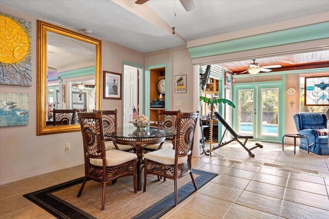 dining area with a textured ceiling and ceiling fan