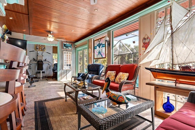 living room with wood ceiling and ceiling fan