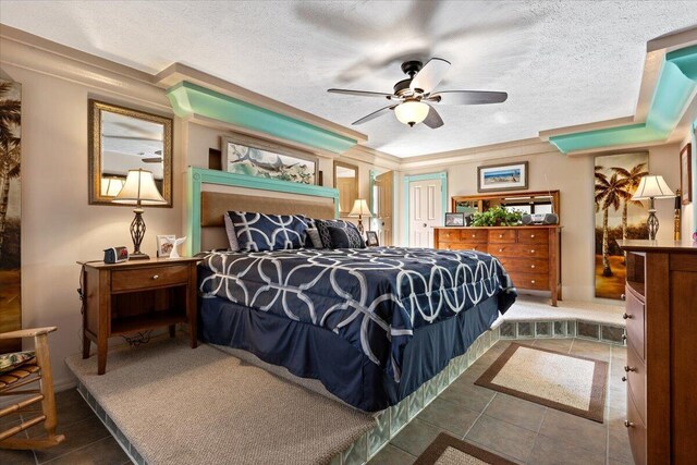 bedroom featuring tile patterned flooring, ceiling fan, and a textured ceiling