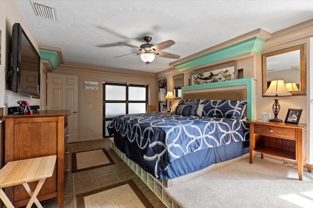 bedroom featuring visible vents, ceiling fan, ornamental molding, a textured ceiling, and tile patterned floors