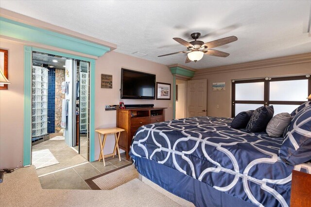 tiled bedroom with crown molding, ceiling fan, and a textured ceiling