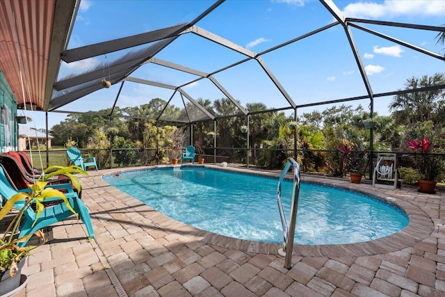 pool with glass enclosure and a patio