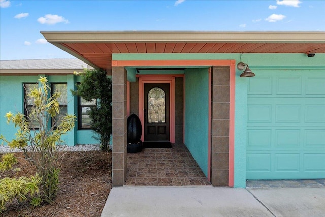 view of exterior entry with a garage