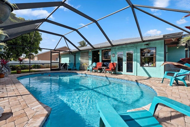 view of swimming pool featuring a lanai and a patio