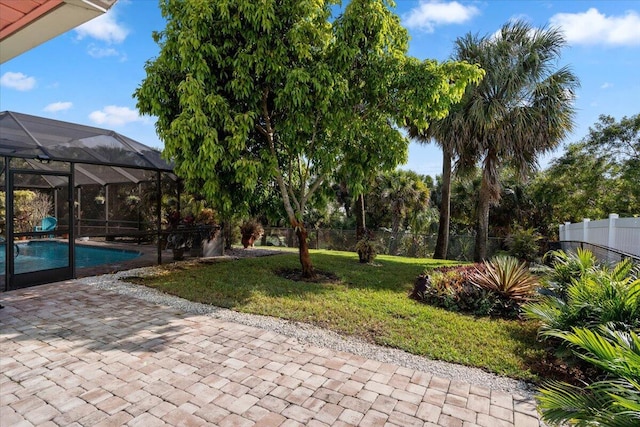 view of yard with glass enclosure, a patio, a fenced in pool, and fence