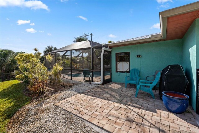 view of patio / terrace featuring glass enclosure