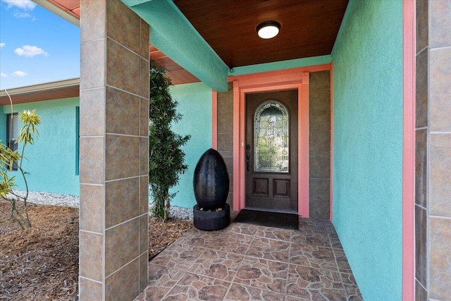 entrance to property featuring stucco siding