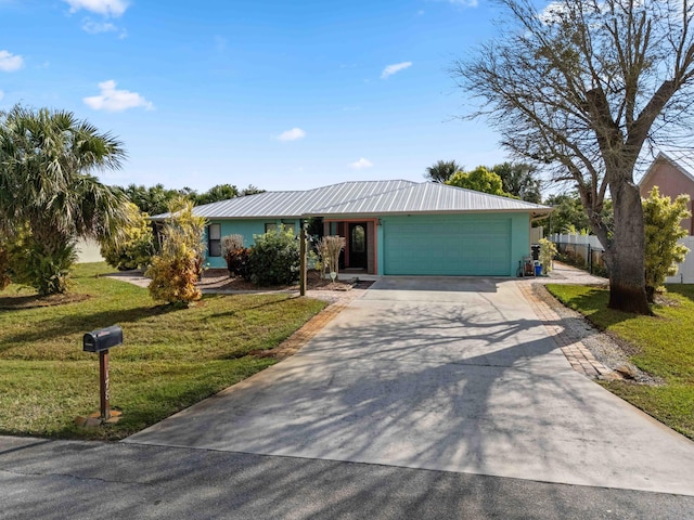 view of front of property with a garage and a front yard