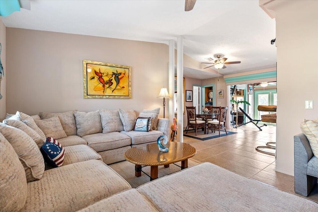 tiled living room featuring lofted ceiling and ceiling fan