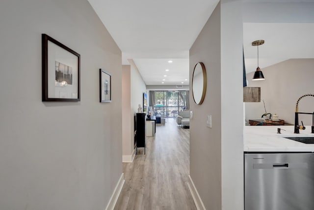 hall featuring sink and light wood-type flooring