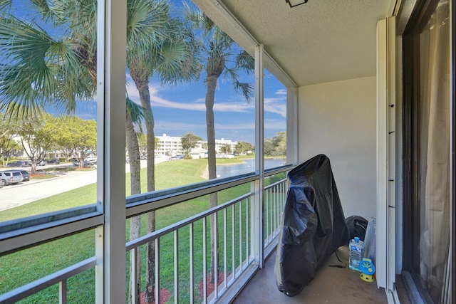 sunroom / solarium with a water view