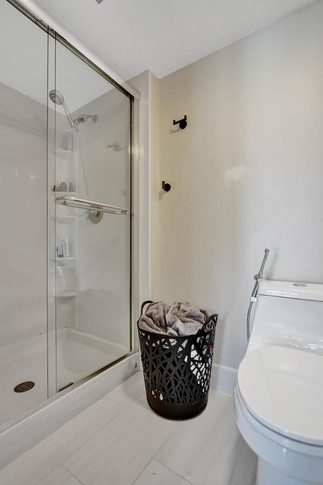 bathroom featuring a shower with door