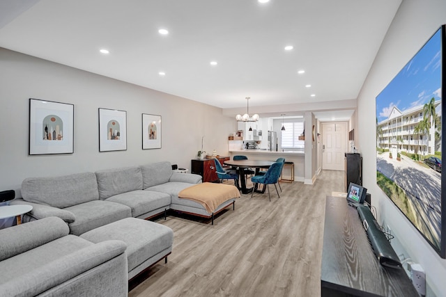 living room with a chandelier and light hardwood / wood-style floors