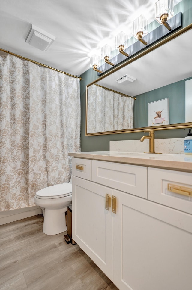 bathroom featuring hardwood / wood-style flooring, vanity, and toilet