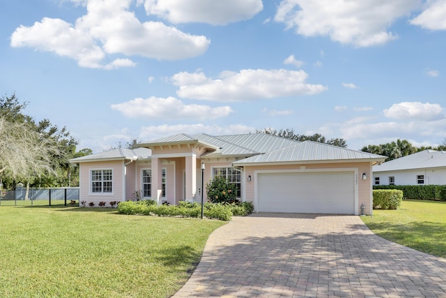 view of front of home with a garage and a front yard