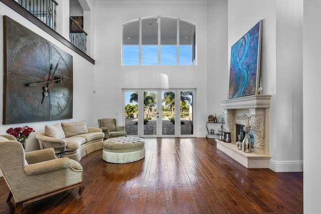 living room featuring a premium fireplace, wood-type flooring, and french doors