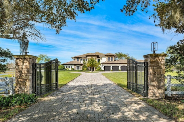 view of gate with a yard