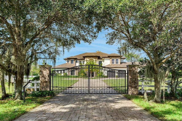 view of gate featuring a lawn