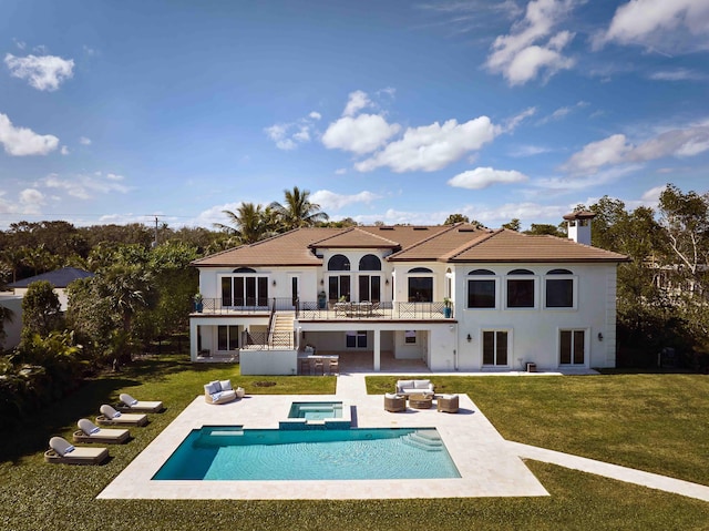back of property featuring a lawn, an outdoor hangout area, a patio, and a balcony
