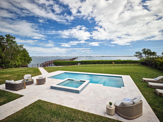 view of swimming pool featuring a water view, a patio, an in ground hot tub, and a lawn