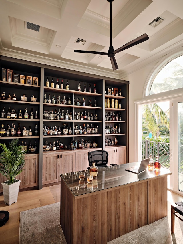 wine room featuring coffered ceiling, visible vents, and ornamental molding