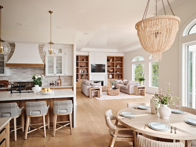 dining space featuring light hardwood / wood-style flooring and a chandelier