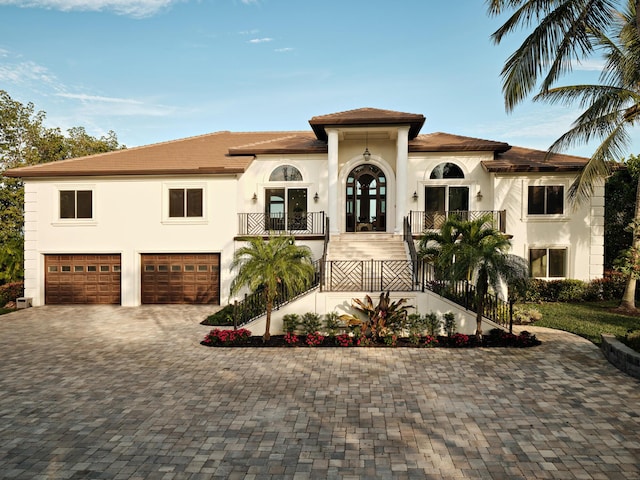 mediterranean / spanish-style house featuring a garage and french doors