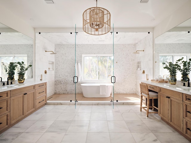 bathroom with independent shower and bath, vanity, tile walls, and a chandelier