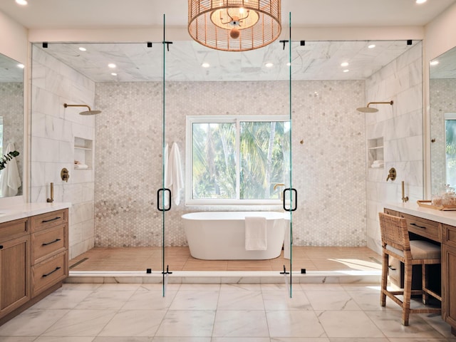 bathroom featuring vanity, shower with separate bathtub, and tile walls