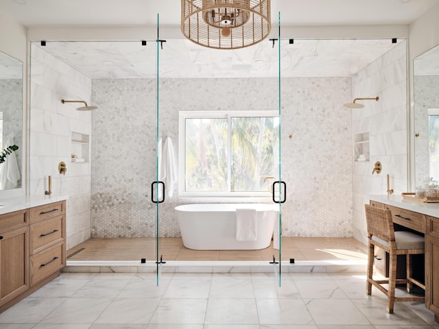 bathroom with independent shower and bath, vanity, and tile walls